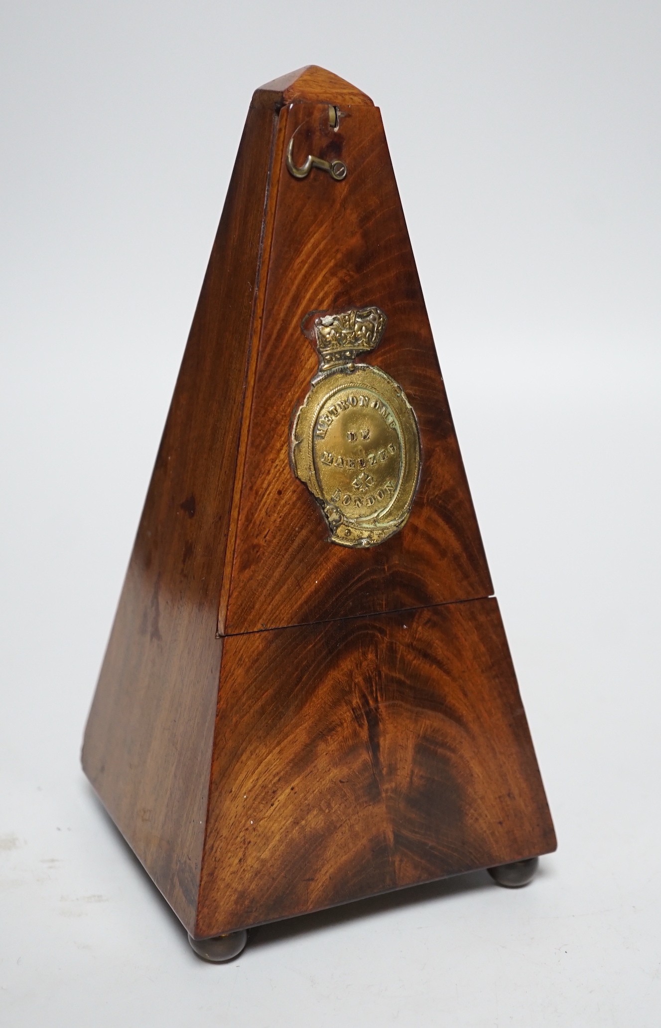 A 19th century mahogany metronome with key, 23ms high